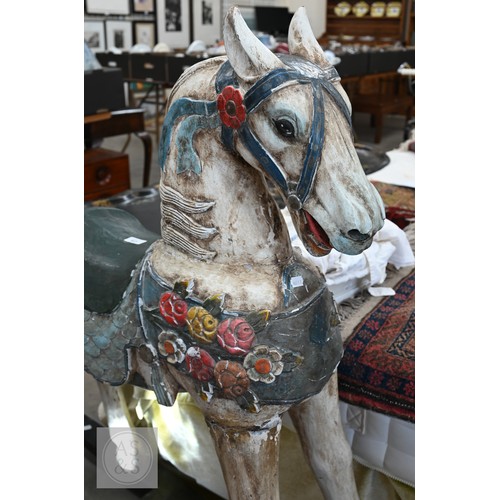 59 - A polychrome painted carved wooden rocking horse, 120 cm high
