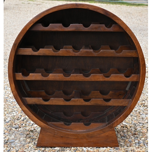 A tropical hardwood circular wine rack, 85 cm high