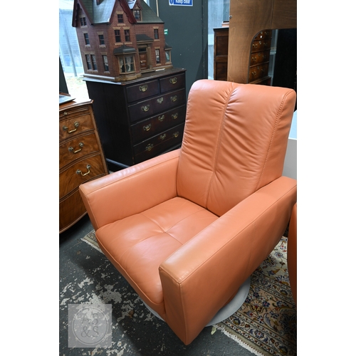 381 - A pair of mid-century modern style swivel chairs in peach leather upholstery, circular brushed alumi... 