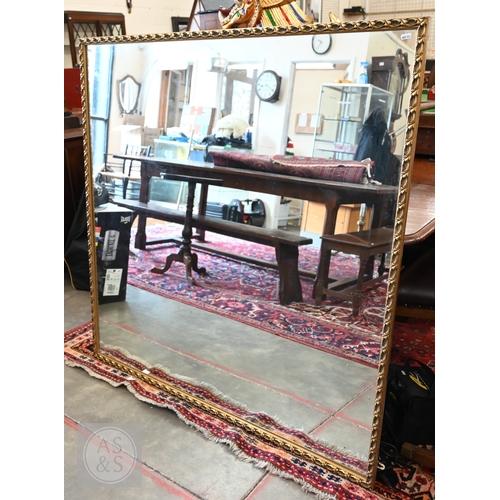 5 - A large square mirror in decorative foliate giltwood frame, 124 x 124 cm