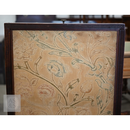 57 - A 19th century mahogany framed draught or fire screen with three-way floral embroidered sliding pane... 