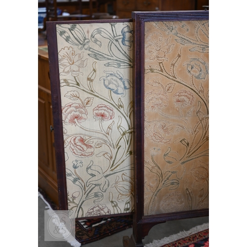 57 - A 19th century mahogany framed draught or fire screen with three-way floral embroidered sliding pane... 