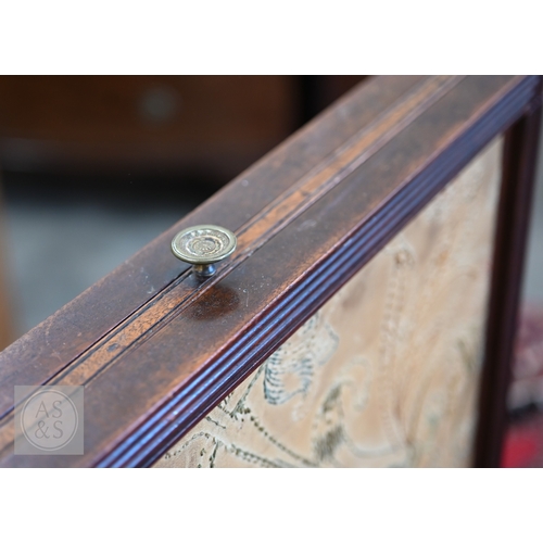 57 - A 19th century mahogany framed draught or fire screen with three-way floral embroidered sliding pane... 