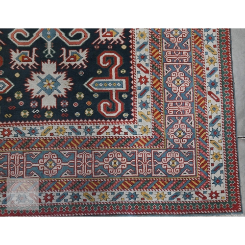 A mid-century Caucasian rug, geometric motif with latch-hooks on blue ...