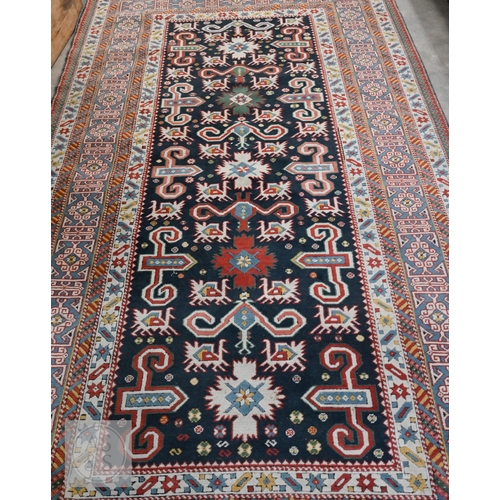 A mid-century Caucasian rug, geometric motif with latch-hooks on blue ...