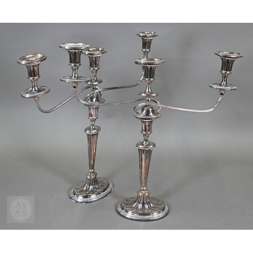 14 - A pair of plated on copper Adam Revival twin-branch candelabra, each with three sconces, on fluted o... 