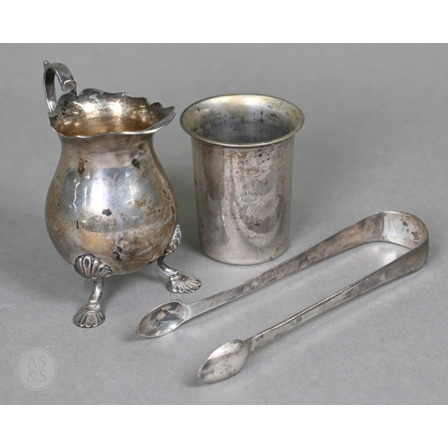 23 - A heavy quality silver pear-shaped cream jug in the Georgian manner, with scroll handle and shell fe... 