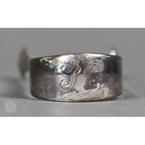 23 - A heavy quality silver pear-shaped cream jug in the Georgian manner, with scroll handle and shell fe... 