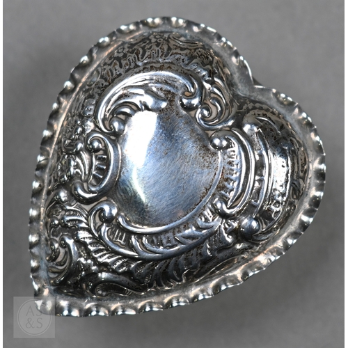 29 - A late Victorian silver heart-shaped trinket box with embossed scroll decoration to the hinged top, ... 