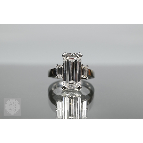 An exceptional diamond ring, the cut-cornered step-cut diamond with ...