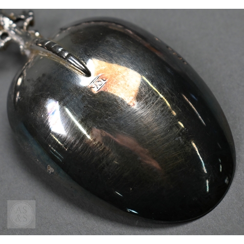 48 - A pair of Continental silver cabinet spoons, the ornate cast stems with seated figure finials, Londo... 