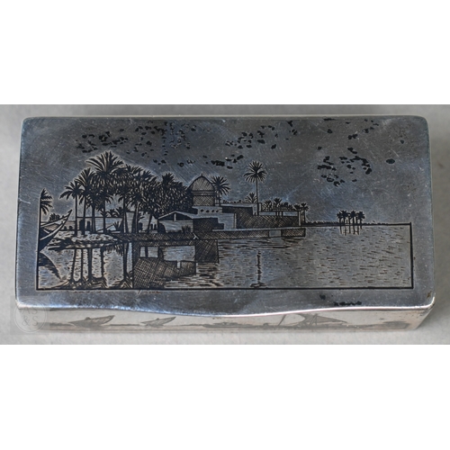 49 - An antique Egyptian unmarked (and untested) white metal snuff box with niello decoration of Nile vie... 