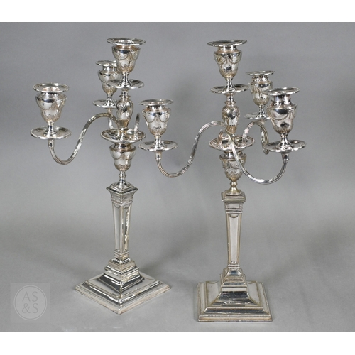 5 - A pair of late Victorian/Edwardian Adam Revival three-branch candelabra, each with four urn-shaped s... 
