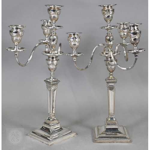 5 - A pair of late Victorian/Edwardian Adam Revival three-branch candelabra, each with four urn-shaped s... 