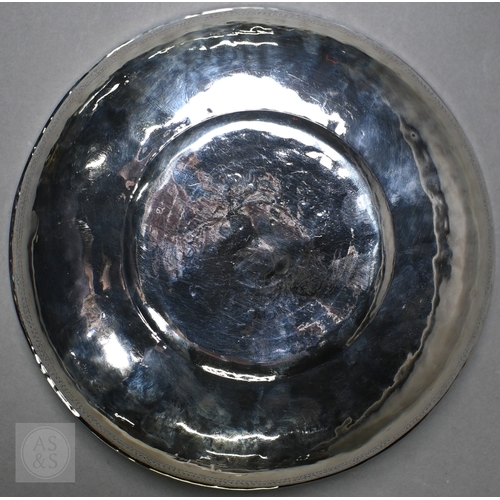 53 - A vintage Middle Eastern white metal bowl with calligraphic central roundel, 14.2ozt, 23cm diameter