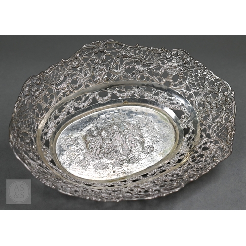 55 - A Continental .800 grade ornate pierced bowl, embossed and chased with Bacchanalian putti, 20cm wide... 