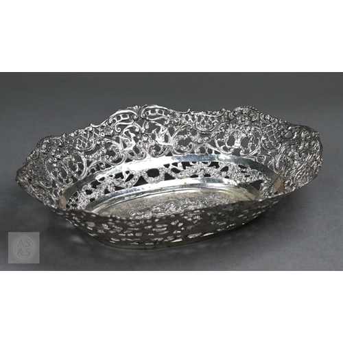 55 - A Continental .800 grade ornate pierced bowl, embossed and chased with Bacchanalian putti, 20cm wide... 