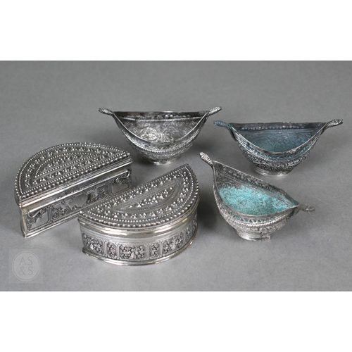 58 - A pair of Indian low-grade silver boxes oc crescent form, richly-embossed with foliage and beading, ... 