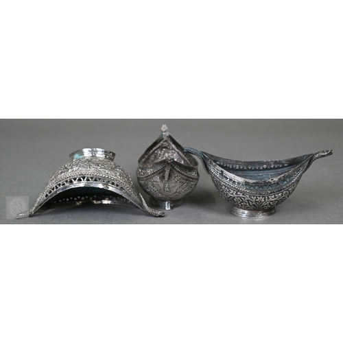 58 - A pair of Indian low-grade silver boxes oc crescent form, richly-embossed with foliage and beading, ... 
