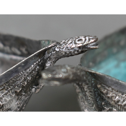 58 - A pair of Indian low-grade silver boxes oc crescent form, richly-embossed with foliage and beading, ... 