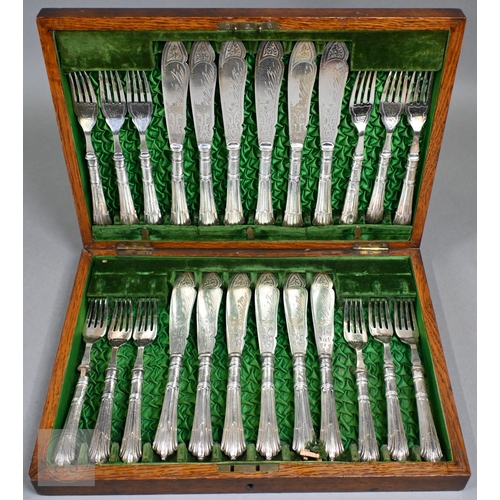 6 - An Edwardian oak-cased set of twelve each Albany pattern fish knives and forks with silver handles a... 