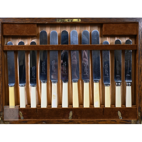 6 - An Edwardian oak-cased set of twelve each Albany pattern fish knives and forks with silver handles a... 