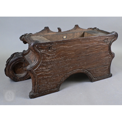 810 - J Huggler (1834-1912) a monumental carved Black Forest clock, late 19th century, carved as a seated ... 