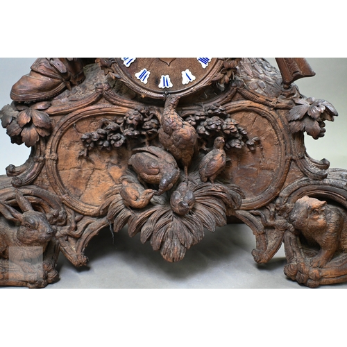 810 - J Huggler (1834-1912) a monumental carved Black Forest clock, late 19th century, carved as a seated ... 