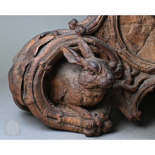 810 - J Huggler (1834-1912) a monumental carved Black Forest clock, late 19th century, carved as a seated ... 