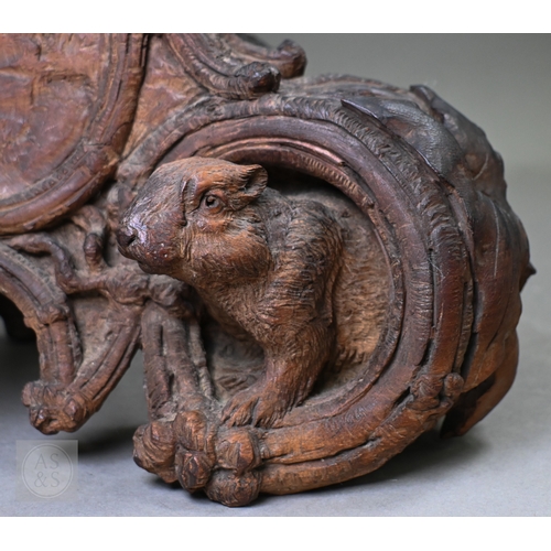 810 - J Huggler (1834-1912) a monumental carved Black Forest clock, late 19th century, carved as a seated ... 