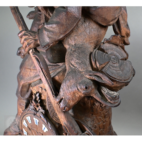 810 - J Huggler (1834-1912) a monumental carved Black Forest clock, late 19th century, carved as a seated ... 