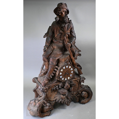810 - J Huggler (1834-1912) a monumental carved Black Forest clock, late 19th century, carved as a seated ... 