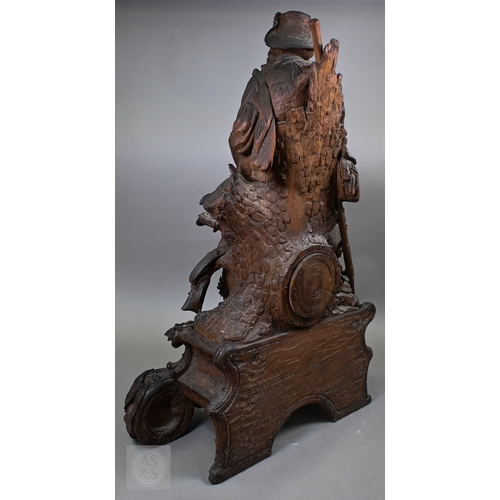 810 - J Huggler (1834-1912) a monumental carved Black Forest clock, late 19th century, carved as a seated ... 