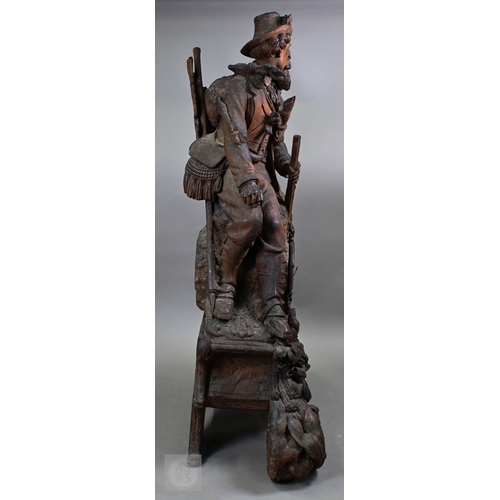 810 - J Huggler (1834-1912) a monumental carved Black Forest clock, late 19th century, carved as a seated ... 