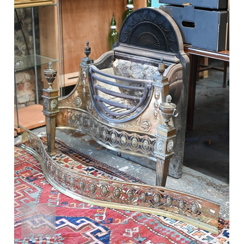 A good George III Adam design brass and cast iron serpentine fire grate, the arched urn back over a triple rail basket and pierced brass gallery surmounted by urns, the verso cast 'No.8 dog stove, Reg. No. 323185', 92 cm w x 43 cm x 92 cm h o/all, to/with the original companion pierced brass serpentine form fender, of conforming design, 149 cm w (2)