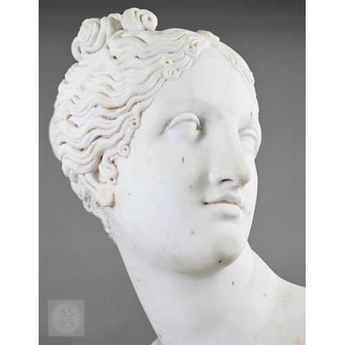 888 - An antique white marble bust of a classical female with ornate hair, on socle base, 62cm high