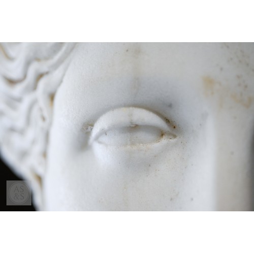 888 - An antique white marble bust of a classical female with ornate hair, on socle base, 62cm high