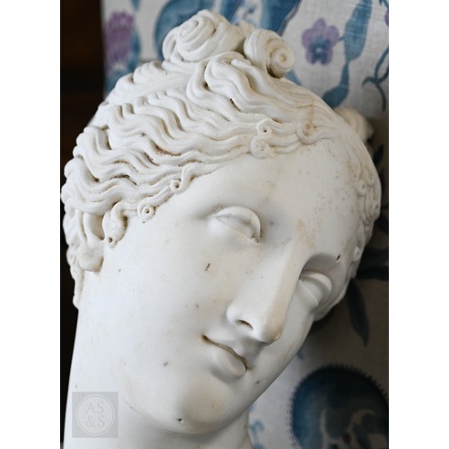 888 - An antique white marble bust of a classical female with ornate hair, on socle base, 62cm high