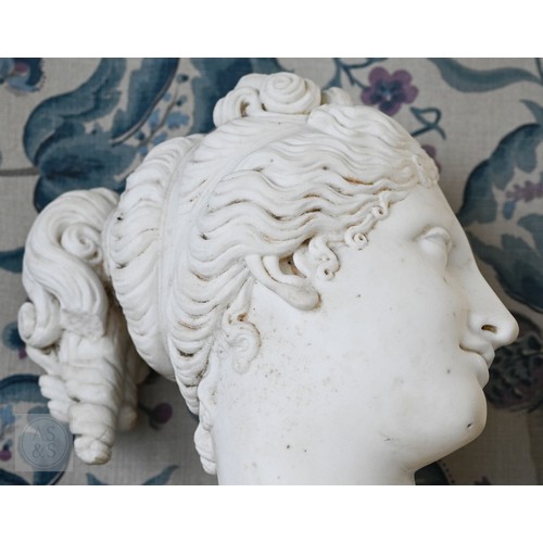 888 - An antique white marble bust of a classical female with ornate hair, on socle base, 62cm high