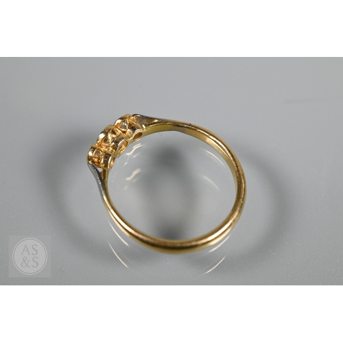 An antique three stone diamond ring, the three collet set diamonds in ...