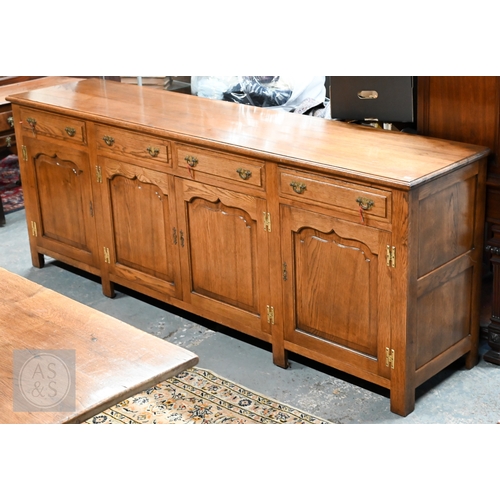Steven W Thorne, Hampshire, a large bespoke four drawer oak low dresser base, over four Arabic arched cupboards in the 18th century style, raised on stiles, 234 cm x 52 cm x 90 cm h