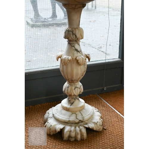 27 - An Italian carved marble table, 19th century, the polished circular top raised on a foliate carved b... 