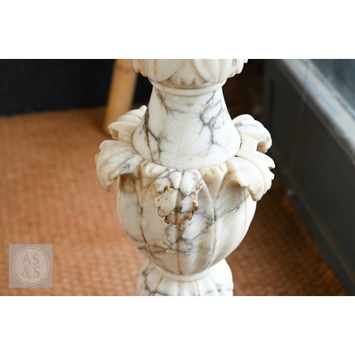 27 - An Italian carved marble table, 19th century, the polished circular top raised on a foliate carved b... 