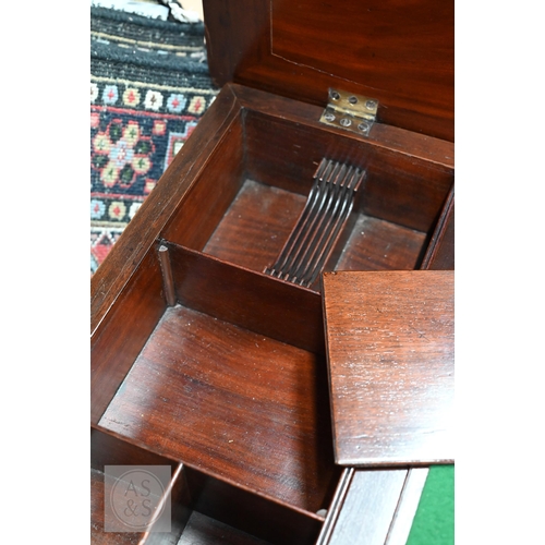 46 - A George III mahogany gentleman's dressing table/desk, the hinged top enclosing an arrangement of dr... 