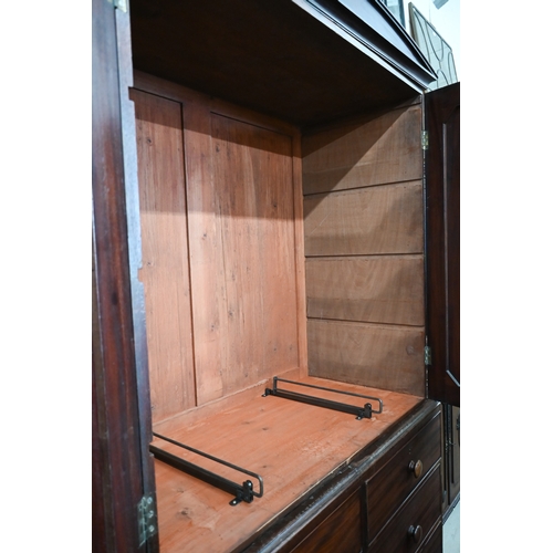 377 - A 19th century mahogany linen press with arched pediment and panelled doors (lacking slides) on ches... 