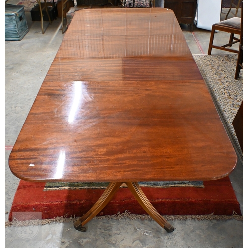 102 - A large Regency style mahogany triple pedestal extending dining table with two extra optional leaves...