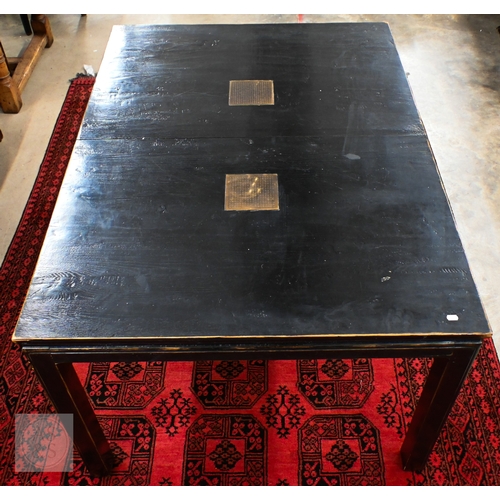 132 - A substantial Chinese black painted extending dining table with four optional leaves, each section i... 