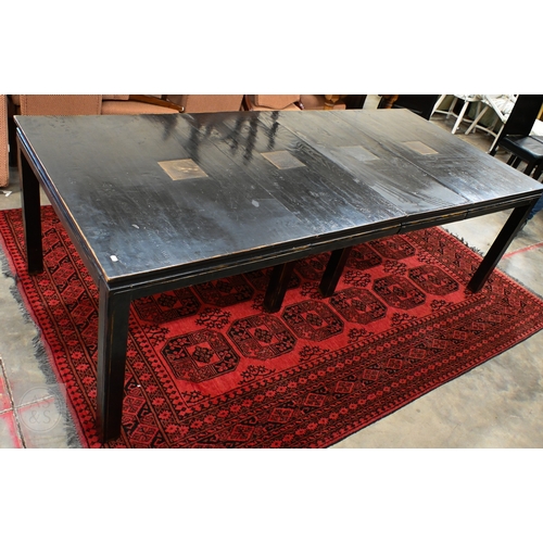 132 - A substantial Chinese black painted extending dining table with four optional leaves, each section i... 