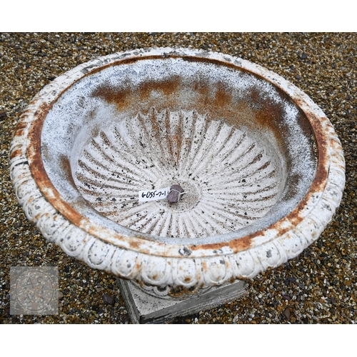 18 - A large Regency style weathered cast iron urn planter raised on a square pedestal base