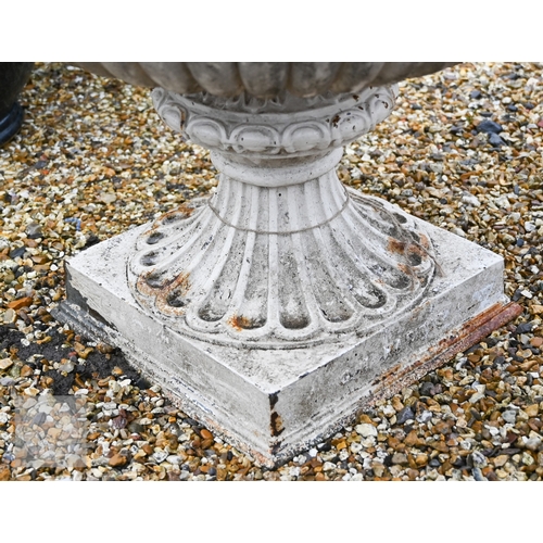 18 - A large Regency style weathered cast iron urn planter raised on a square pedestal base